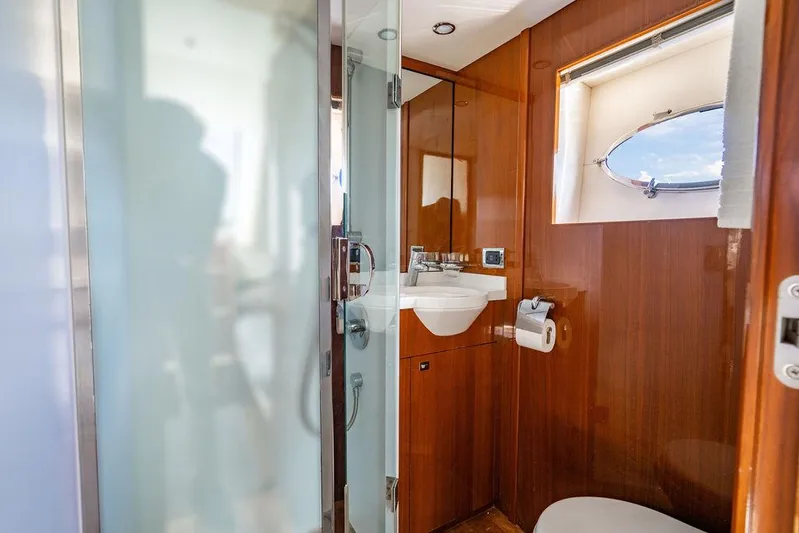  Yacht Photos Pics Luxurious bathroom in 2010 Princess V78 yacht with wooden accents and modern fixtures.
