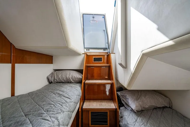  Yacht Photos Pics Interior of 2010 Princess V78 yacht with twin beds and wooden stairs.