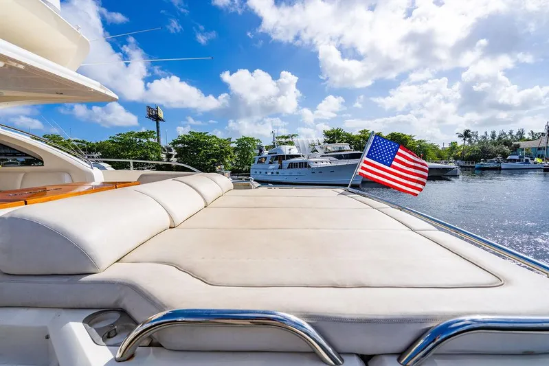  Yacht Photos Pics Luxury 2010 Princess V78 yacht with sun deck and American flag on a sunny day.
