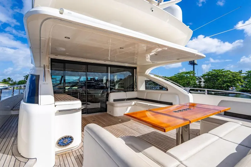  Yacht Photos Pics Luxurious 2010 Princess V78 yacht deck with seating and table under blue sky.
