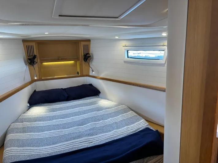 Hallucination Yacht Photos Pics Cozy cabin interior of 2012 Bavaria Vision 46 yacht with bed and window.