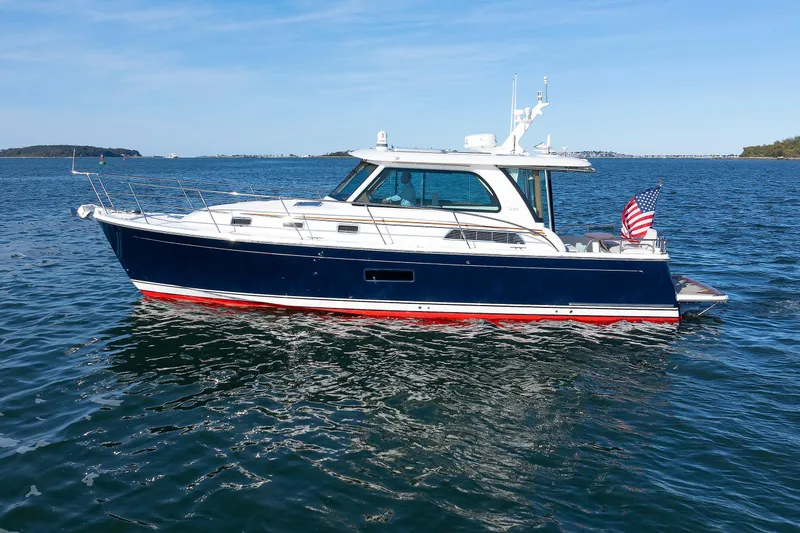  Yacht Photos Pics 2022 Sabre 38 SE yacht cruising on open water under clear blue skies.