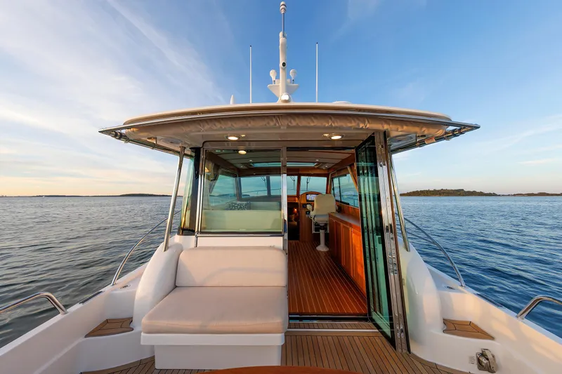  Yacht Photos Pics 2022 Sabre 38 SE yacht with open cabin, cruising on calm waters at sunset.