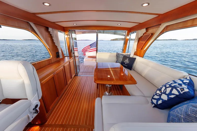  Yacht Photos Pics Luxurious interior of 2022 Sabre 38 SE yacht with elegant wood finish and comfortable seating.
