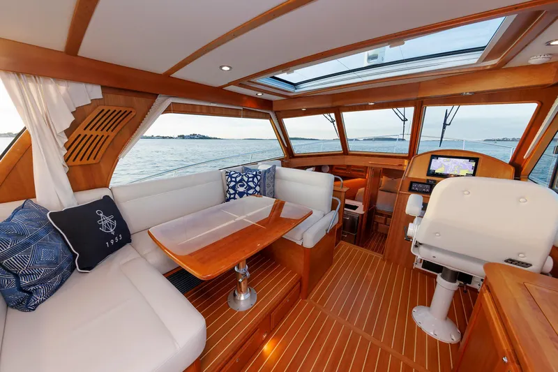  Yacht Photos Pics Luxurious interior of 2022 Sabre 38 SE yacht with elegant wood finish and ocean view.