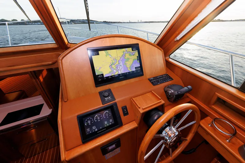  Yacht Photos Pics Helm of 2022 Sabre 38 SE yacht with navigation screens and wooden finish.