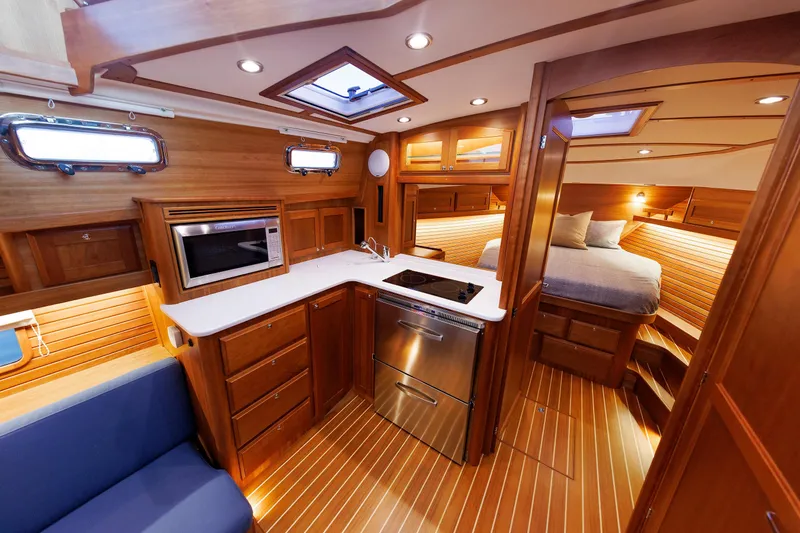  Yacht Photos Pics Luxurious interior of 2022 Sabre 38 SE yacht with modern kitchen and cozy bedroom.