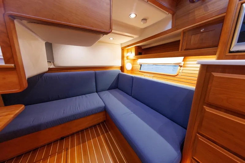  Yacht Photos Pics Interior of 2022 Sabre 38 SE yacht with blue seating and wooden finishes.