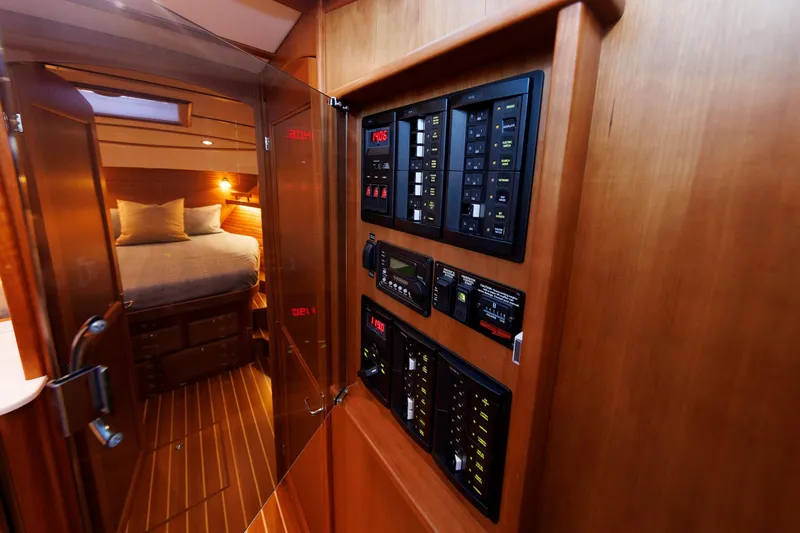  Yacht Photos Pics 2022 Sabre 38 SE yacht interior with control panel and cozy bedroom.