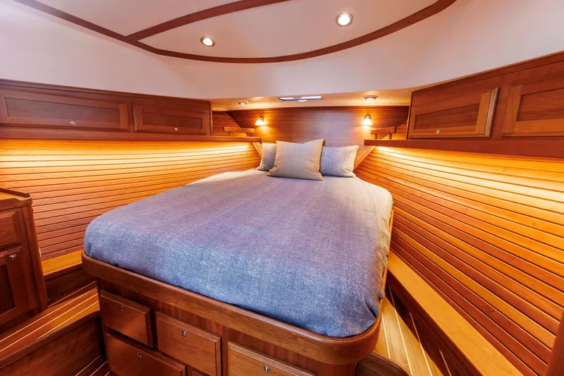  Yacht Photos Pics Luxurious wooden cabin interior of 2022 Sabre 38 SE yacht with cozy bed.