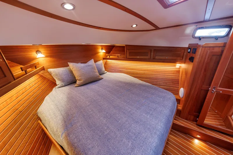  Yacht Photos Pics Luxurious cabin interior of 2022 Sabre 38 SE yacht with cozy bedding and warm lighting.