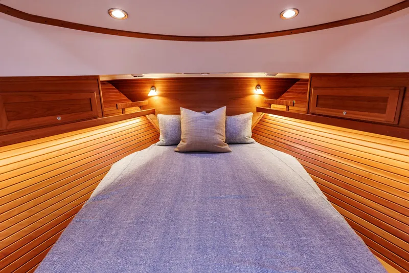  Yacht Photos Pics Luxurious cabin interior of 2022 Sabre 38 SE yacht with cozy bedding and warm lighting.