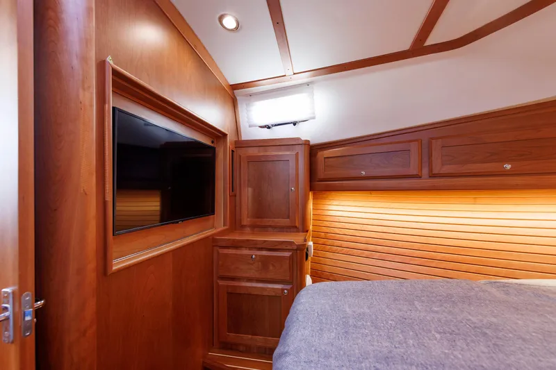  Yacht Photos Pics Interior of 2022 Sabre 38 SE yacht with wood paneling and mounted TV.