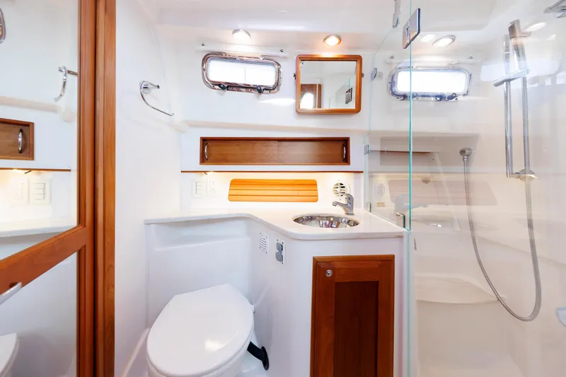  Yacht Photos Pics 2022 Sabre 38 SE yacht bathroom with modern fixtures and wooden accents.
