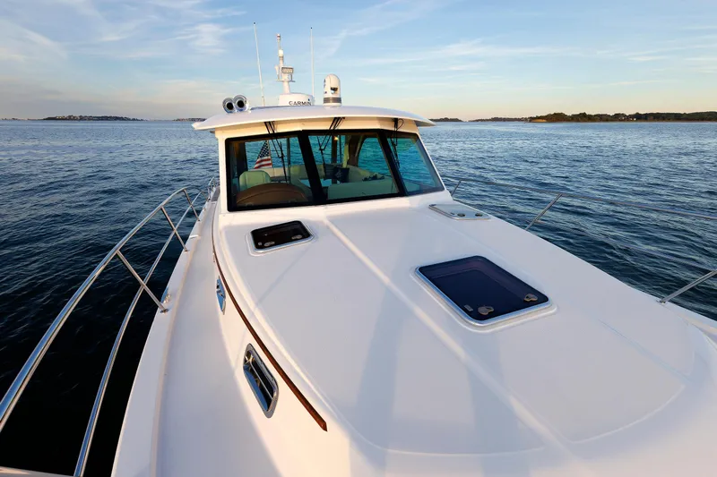  Yacht Photos Pics 2022 Sabre 38 SE yacht cruising on calm waters at sunset.