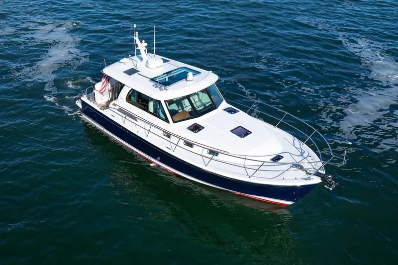  Yacht Photos Pics 2022 Sabre 38 SE yacht cruising on open water, aerial view.