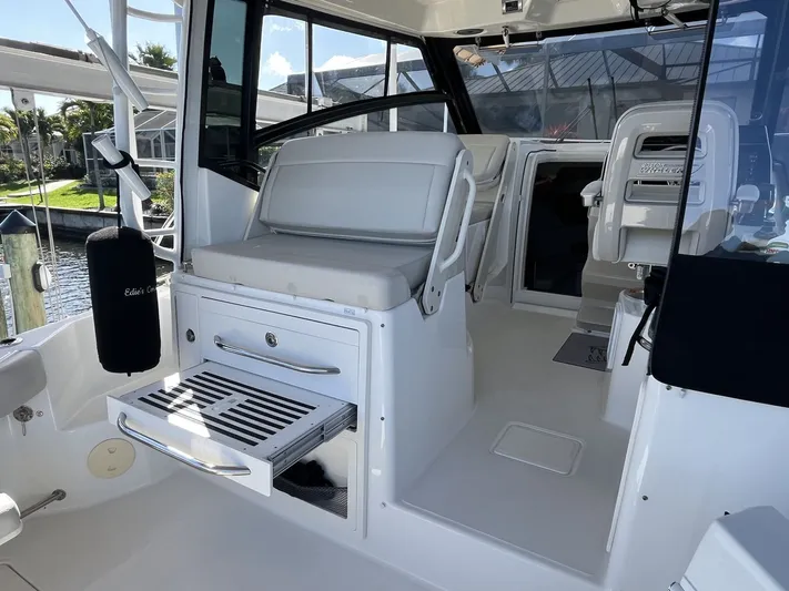 Yacht Photos Pics Interior of 2023 Boston Whaler 325 Conquest with seating and storage area.