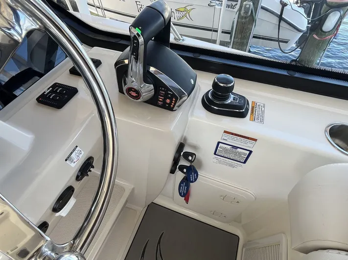  Yacht Photos Pics 2023 Boston Whaler 325 Conquest helm with controls and steering wheel.