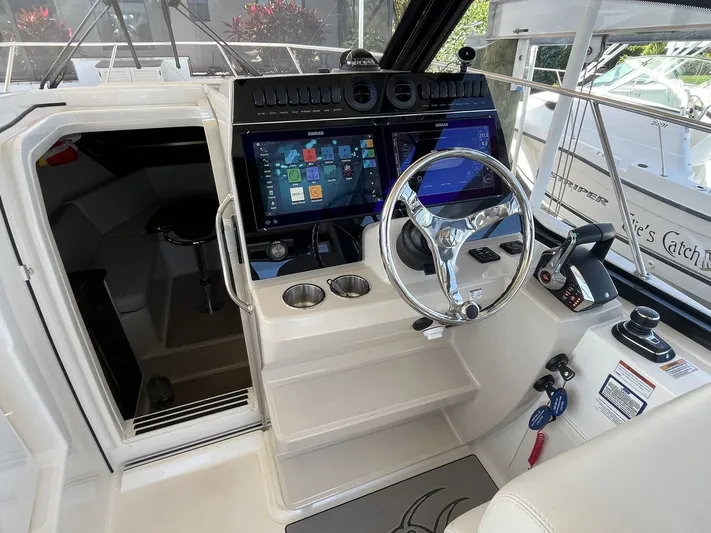  Yacht Photos Pics Interior view of 2023 Boston Whaler 325 Conquest cockpit with modern controls.