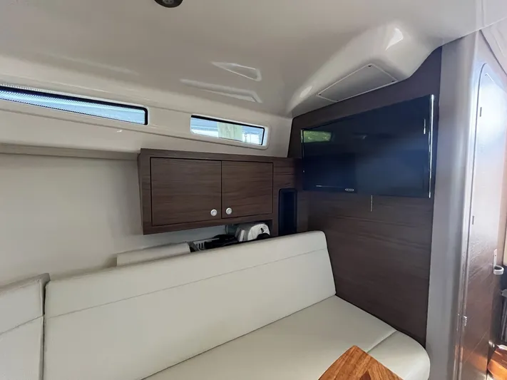  Yacht Photos Pics Interior of 2023 Boston Whaler 325 Conquest with sofa and TV.