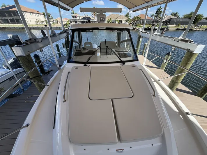  Yacht Photos Pics Boston Whaler 325 Conquest 2023 on a dock with waterfront view.
