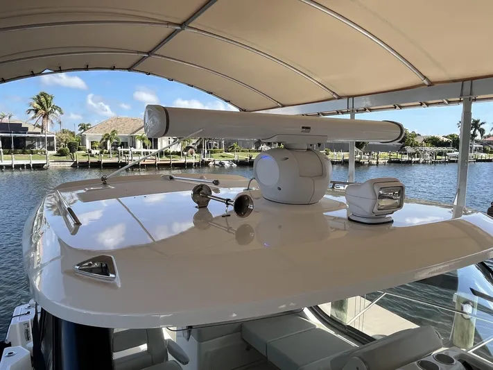 Yacht Photos Pics Boston Whaler 325 Conquest 2023 on calm water under sunshade.