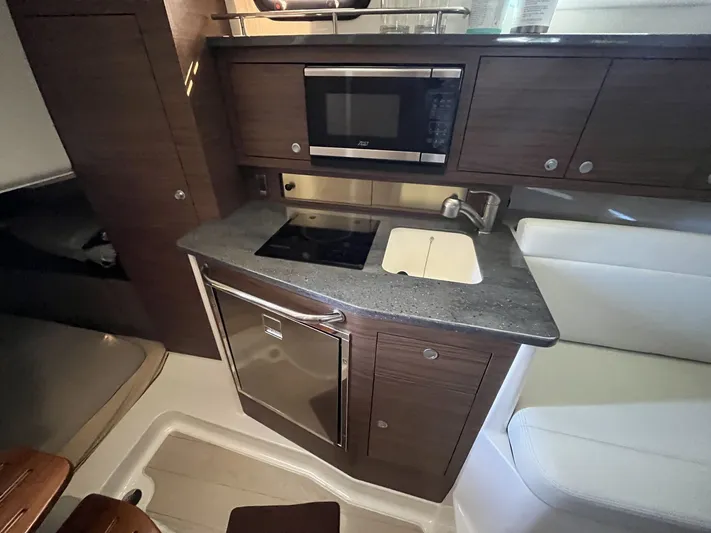  Yacht Photos Pics Interior of 2023 Boston Whaler 325 Conquest with kitchenette and microwave.