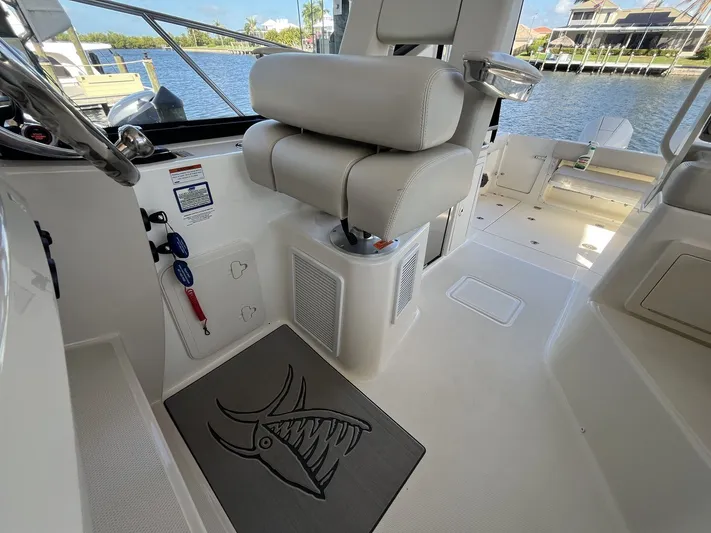  Yacht Photos Pics Interior of 2023 Boston Whaler 325 Conquest with seating and helm area.