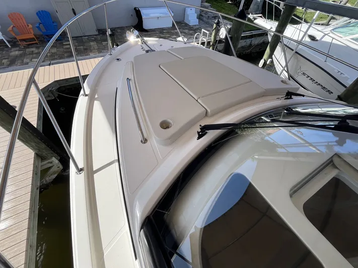  Yacht Photos Pics Boston Whaler 325 Conquest 2023 on a dock, bow deck view.