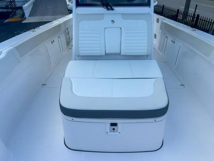  Yacht Photos Pics 2025 Edgewater 340CC boat interior with white seating and storage compartments.