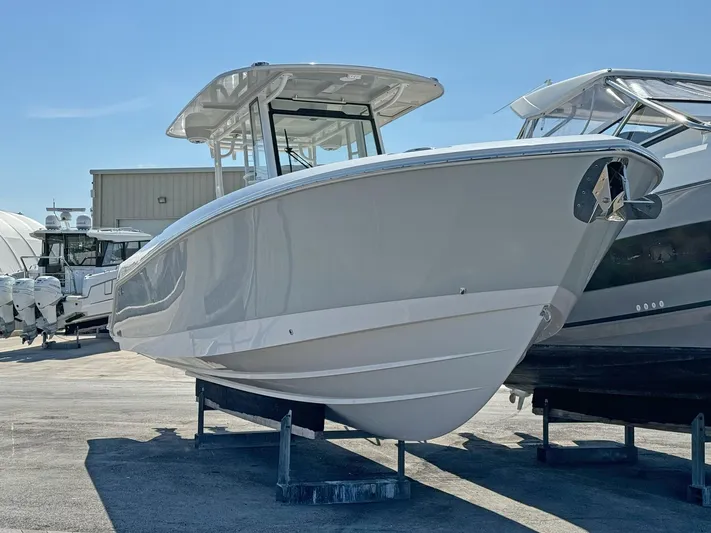  Yacht Photos Pics 2025 Edgewater 340CC boat displayed outdoors on a sunny day.