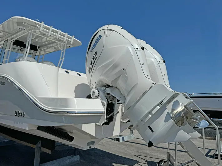  Yacht Photos Pics Edgewater 340CC 2025 boat with Yamaha outboard motor under clear blue sky.