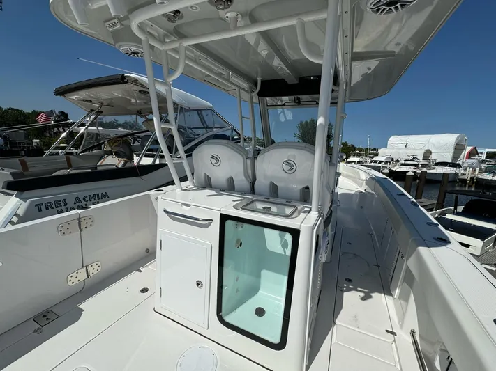  Yacht Photos Pics 2025 Edgewater 340CC boat interior with helm station and seating, docked at marina.