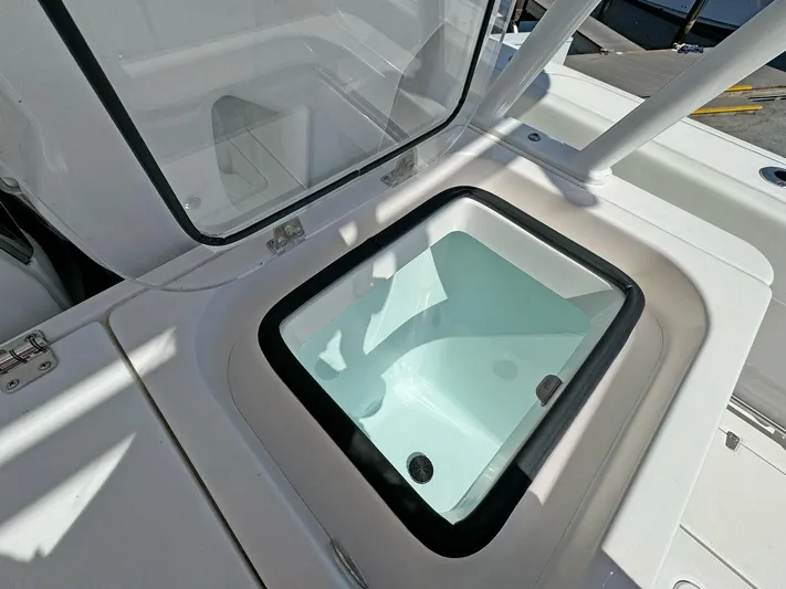  Yacht Photos Pics Livewell compartment on 2025 Edgewater 340CC boat, open lid, white interior.