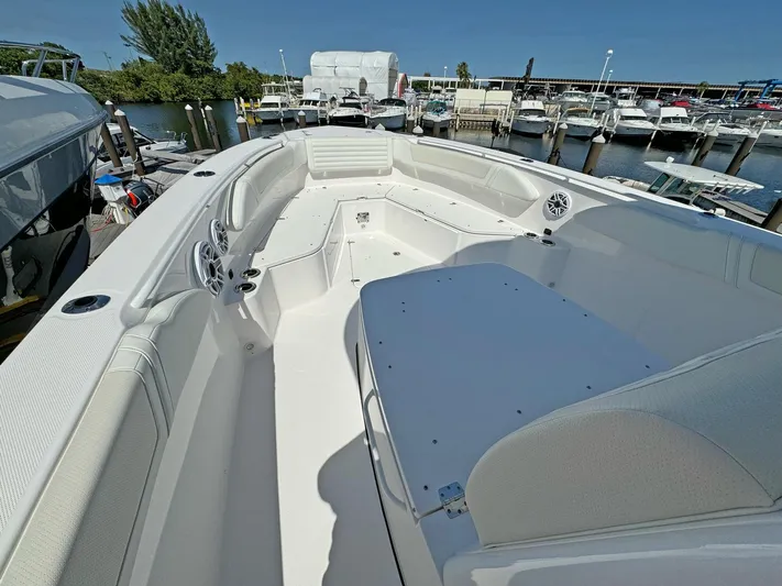  Yacht Photos Pics 2025 Edgewater 340CC boat interior at marina, showcasing spacious seating and modern design.