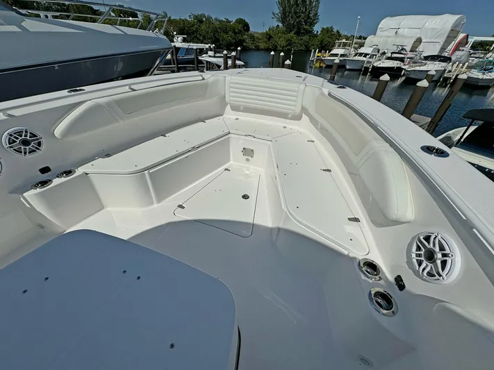  Yacht Photos Pics 2025 Edgewater 340CC boat interior with spacious seating and modern amenities at a marina.