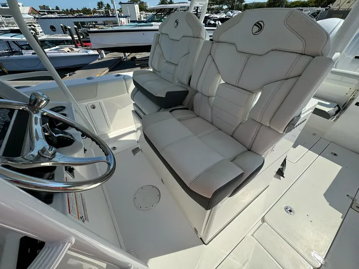  Yacht Photos Pics 2025 Edgewater 340CC boat interior with dual captain's seats and steering wheel.
