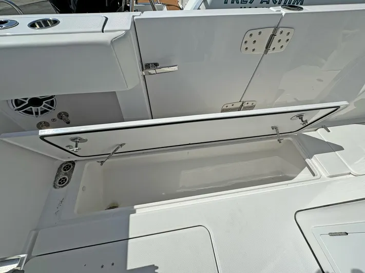  Yacht Photos Pics Open storage compartment on 2025 Edgewater 340CC boat, showcasing interior space and design.