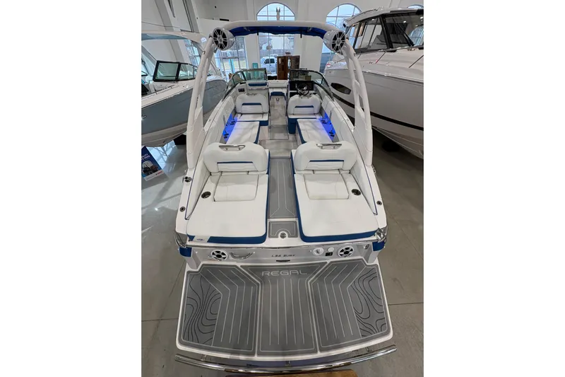  Yacht Photos Pics 2026 Regal LS6 Surf boat with sleek interior and modern design in showroom.