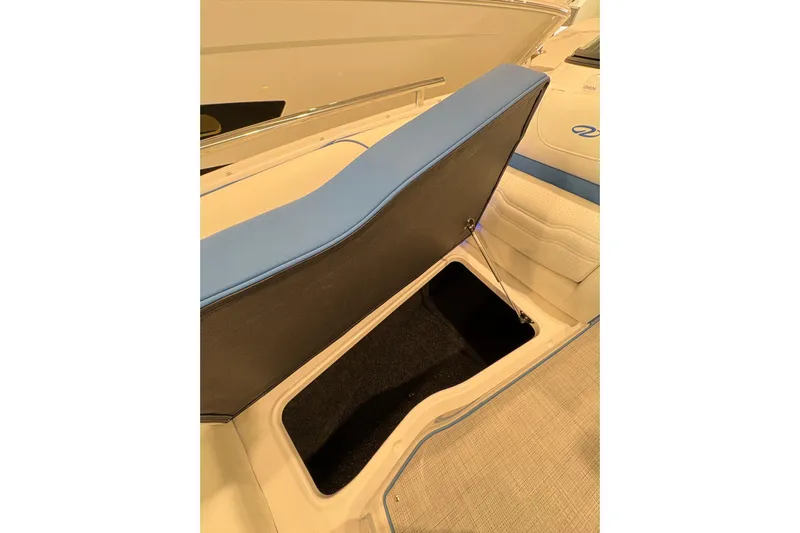  Yacht Photos Pics 2026 Regal LS6 Surf boat with open storage compartment, featuring blue and beige interior.