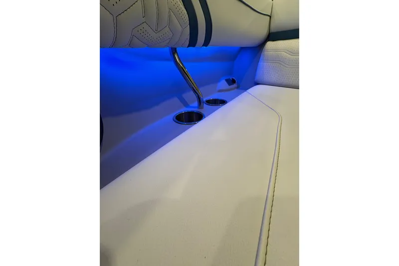  Yacht Photos Pics 2026 Regal LS6 Surf interior with blue LED lighting and cup holders.