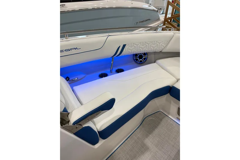 Yacht Photos Pics 2026 Regal LS6 Surf boat interior with blue LED lighting and white cushioned seating.