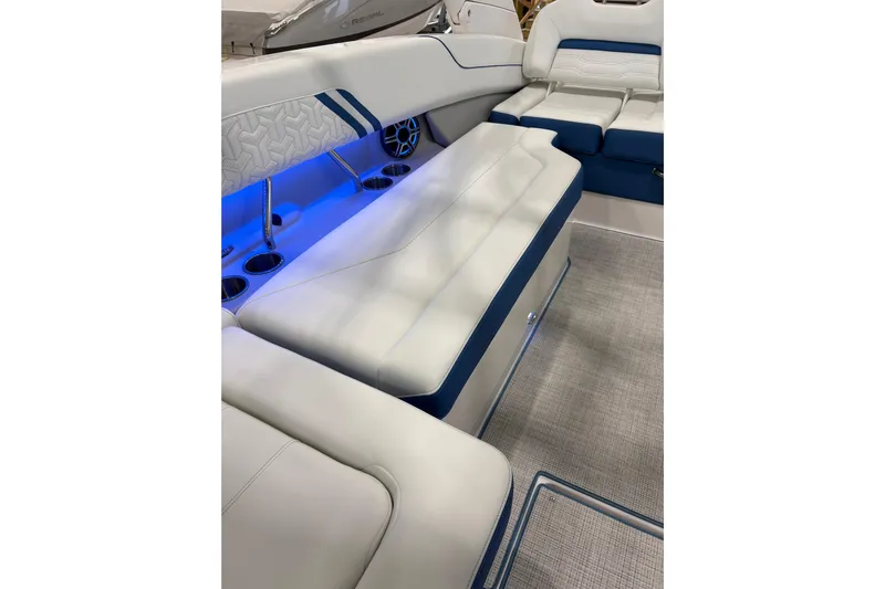  Yacht Photos Pics Luxurious interior of 2026 Regal LS6 Surf boat with blue LED lighting and cushioned seating.