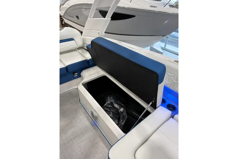  Yacht Photos Pics 2026 Regal LS6 Surf boat interior with open storage compartment and blue accents.