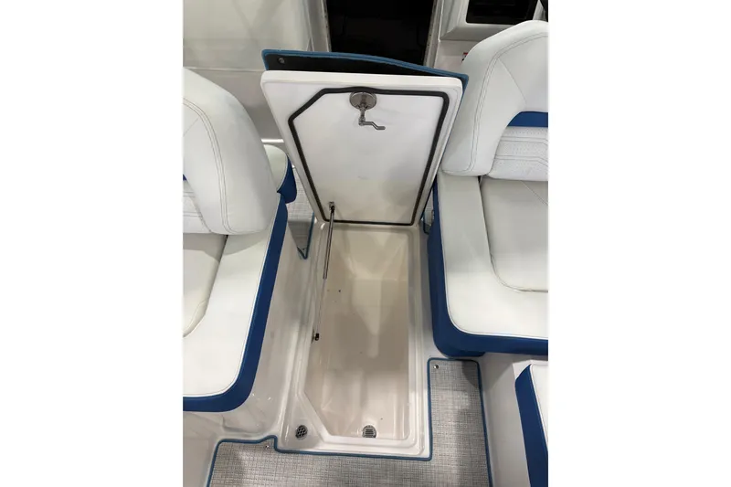  Yacht Photos Pics 2026 Regal LS6 Surf boat interior storage compartment with white and blue seating.