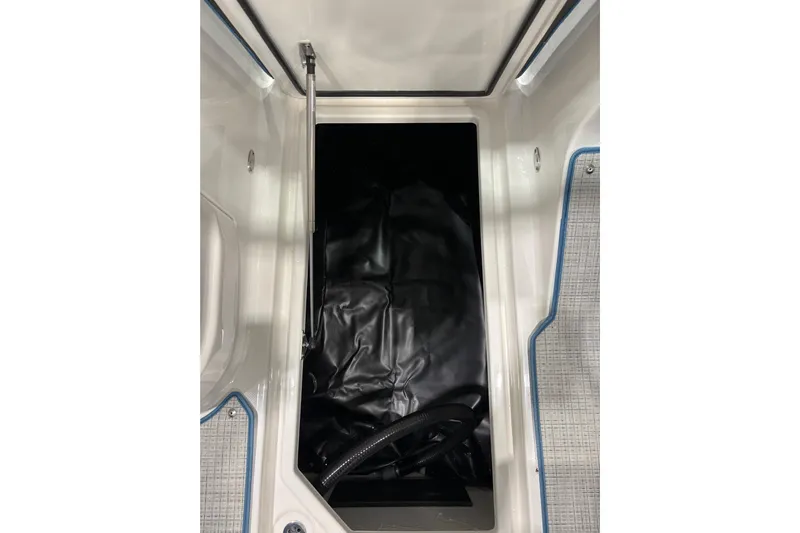  Yacht Photos Pics 2026 Regal LS6 Surf boat storage compartment with black interior and textured flooring.