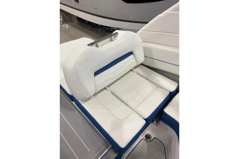  Yacht Photos Pics 2026 Regal LS6 Surf boat interior with white and blue cushioned seating.
