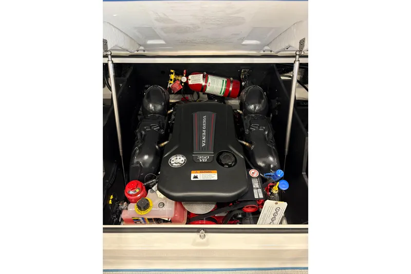  Yacht Photos Pics 2026 Regal LS6 Surf engine compartment with Volvo Penta V6, featuring fire extinguisher.