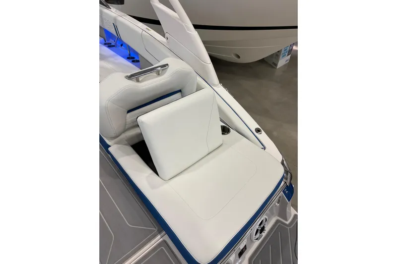  Yacht Photos Pics 2026 Regal LS6 Surf boat interior with white cushioned seating and blue accents.