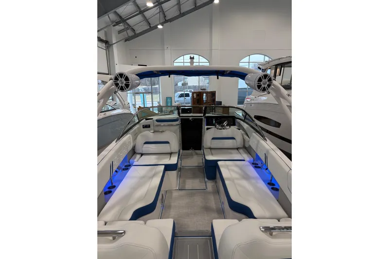  Yacht Photos Pics 2026 Regal LS6 Surf boat interior with blue LED lighting and white seating.